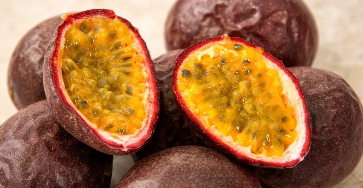 Fresh passion fruits clustered together showing their round purple shape